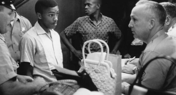 In March and July of 1960, students staged a series of peaceful protests against the segregation of the libraries. In what might be called "read-ins," groups of young African Americans entered the white library and quietly used its resources, perusing shelves of books or sitting at tables reading. Two of these protests resulted in the arrest of the participants on charges of disturbing the peace. (Image from the James Wilson Photograph Collection, courtesy of the Upcountry History Museum)